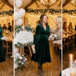 What to wear to a winter baby shower — woman in emerald velvet midi dress at warmly lit candlelit venue