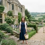 Woman in a navy linen midi dress and cream cardigan demonstrating old money aesthetic dress outfit ideas