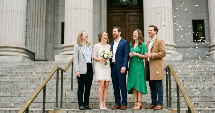 Wedding guests in semi-formal outfits standing on courthouse steps after a ceremony